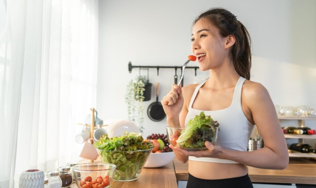 Mulher se alimentando se forma saudável demonstrando como a falta de alimentação saudável pode contribuir para uma testosterona baixa